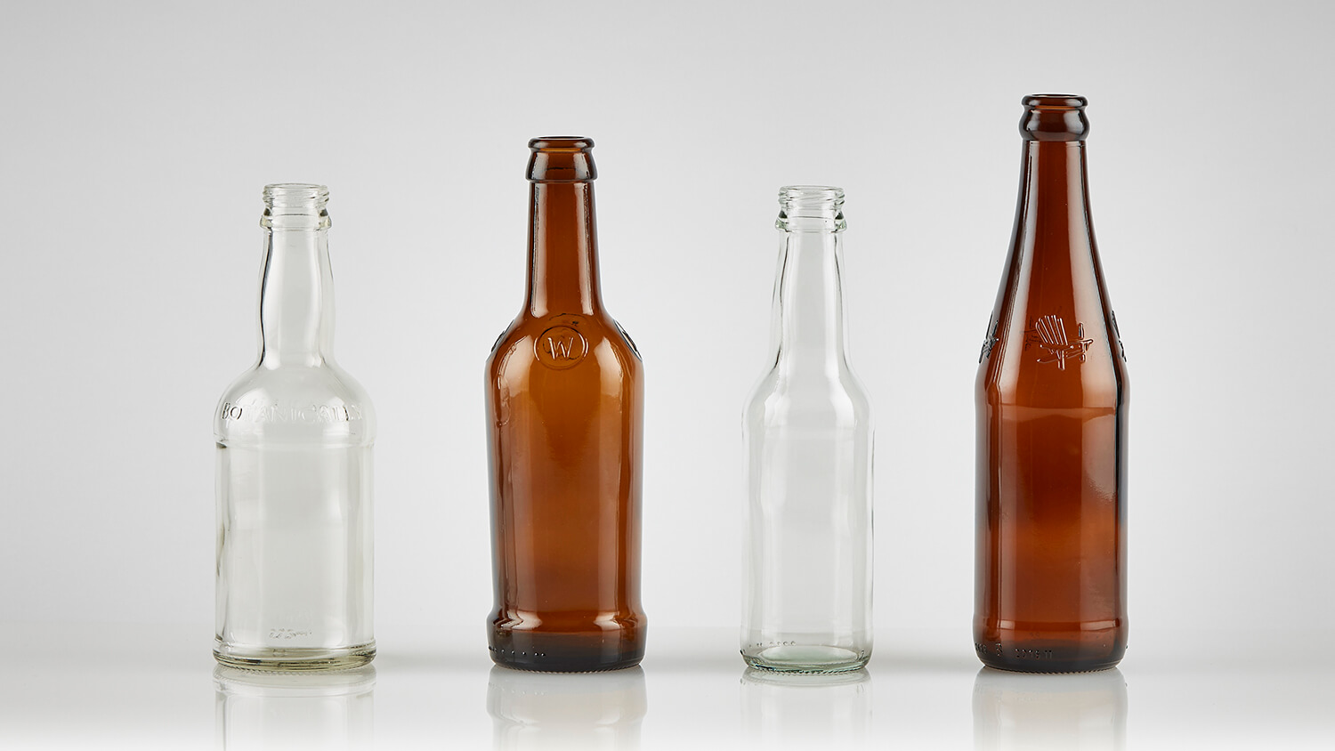 Glass beer bottles by Evergreen, with different sizes and colors.