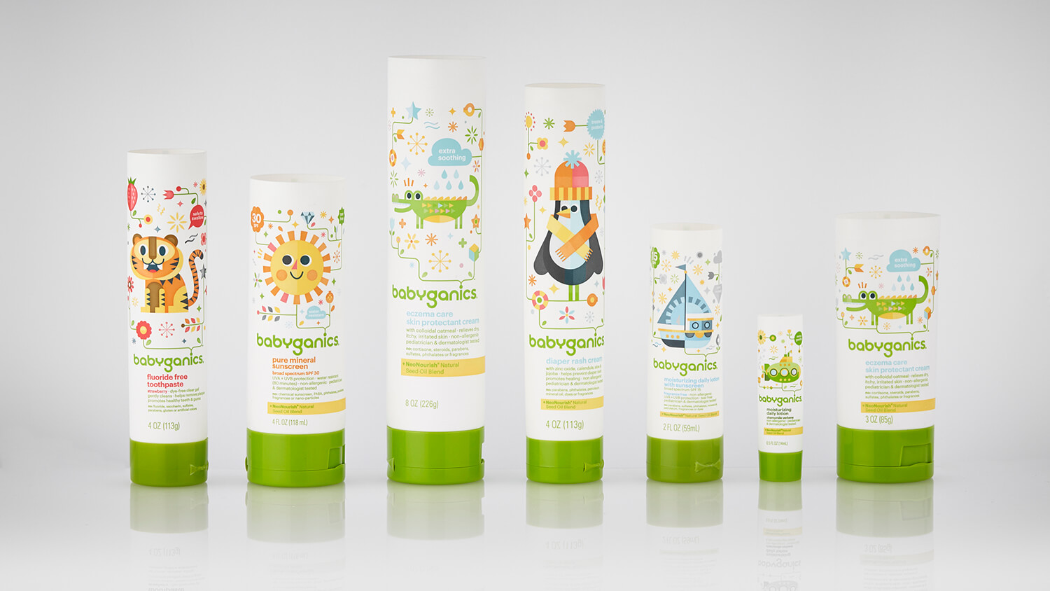 Babyganics branded baby care packaging including toothpaste, sunscreen, diaper rash cream, eczema care, and lotion tubes.