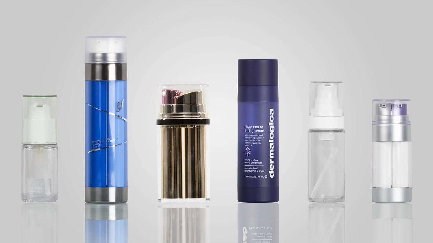 Custom-colored airless bottles in coordinated brand palettes for personal care.
