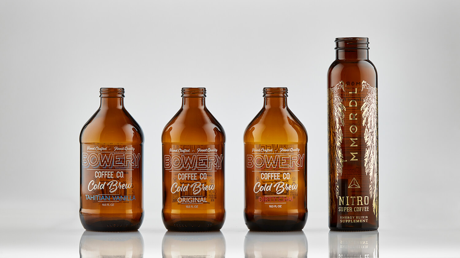 Branded and decorated cold brew coffee beverage bottles.