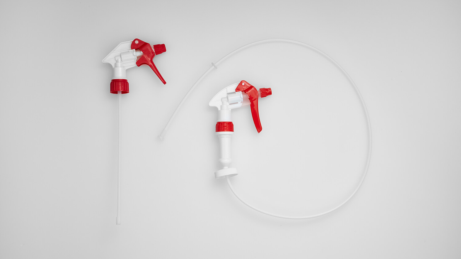 Industrial trigger sprayer in red and white with heavy-duty pump design.