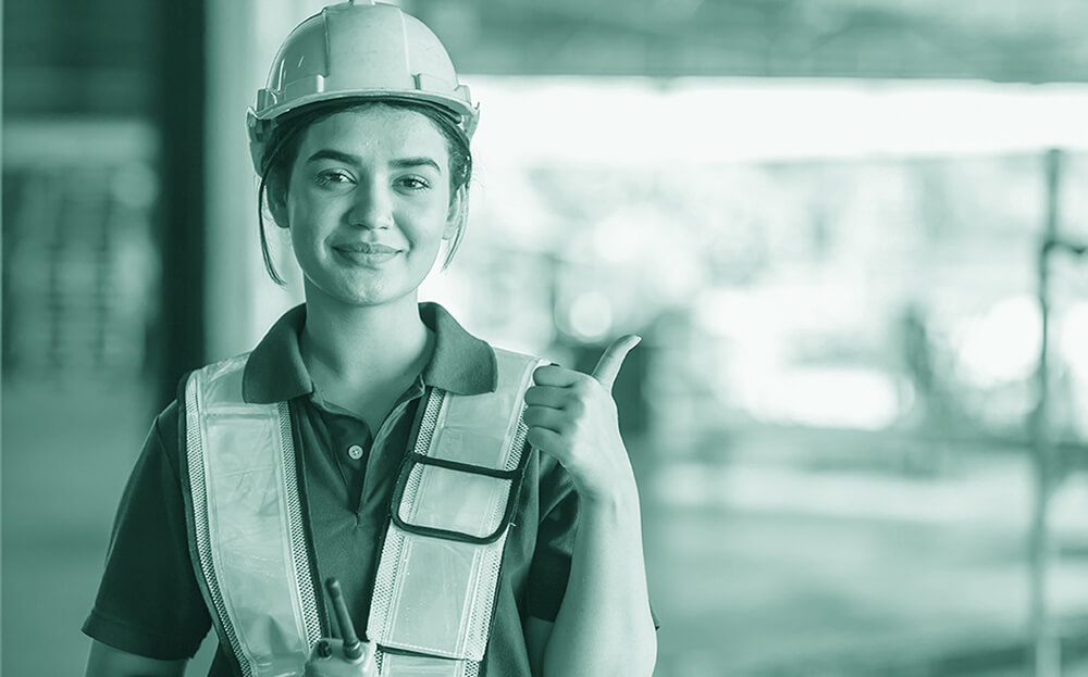 safety-inventory-warehousing A warehouse worker in a construction vest giving a thumbs up