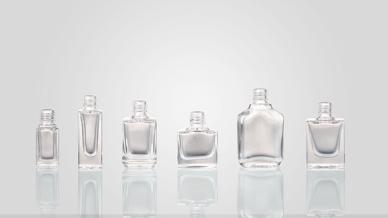 Nail polish bottles in assorted shapes and sizes.