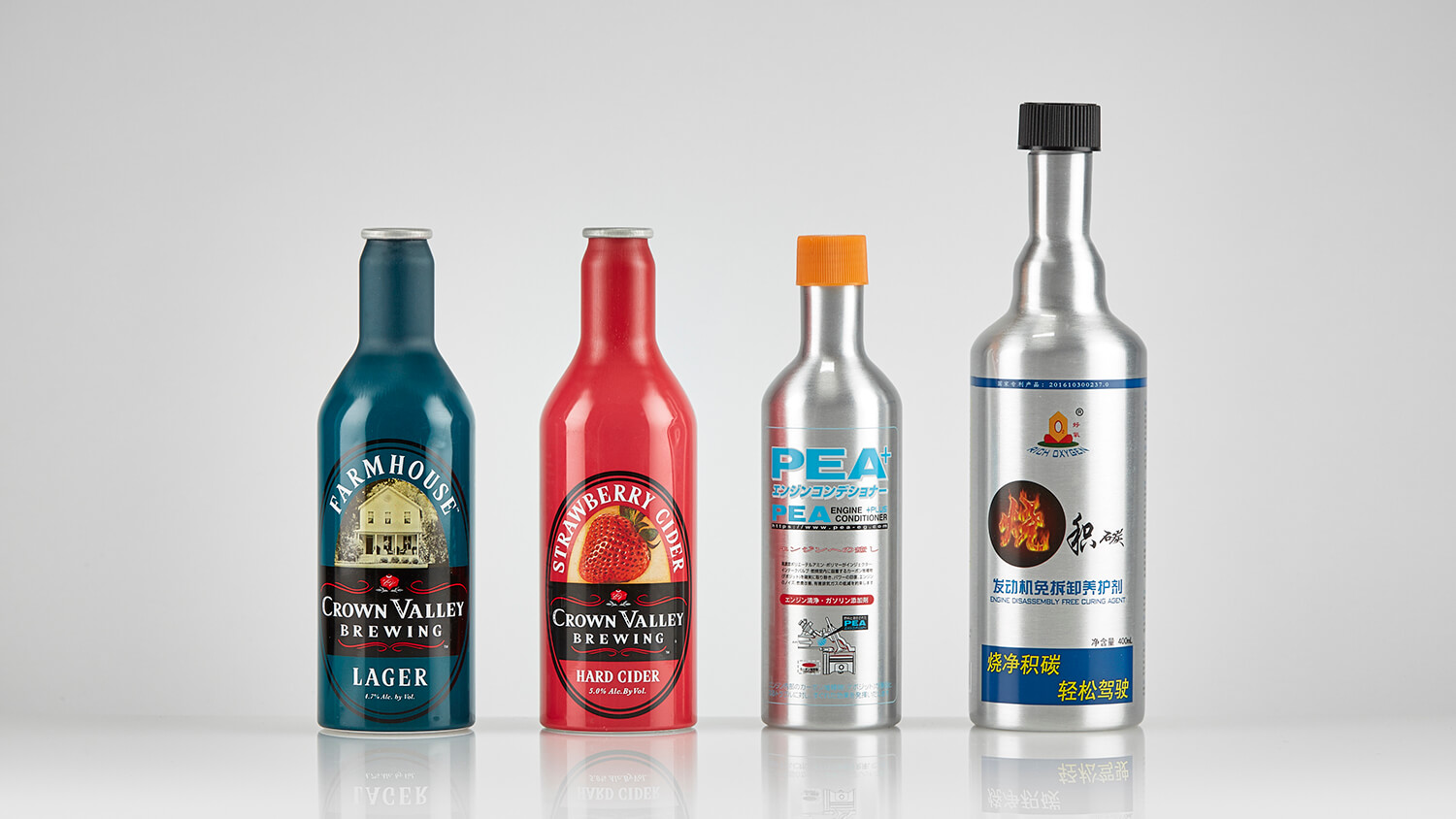 Custom-shaped aluminum bottles designed for hard cider and engine conditioner products.