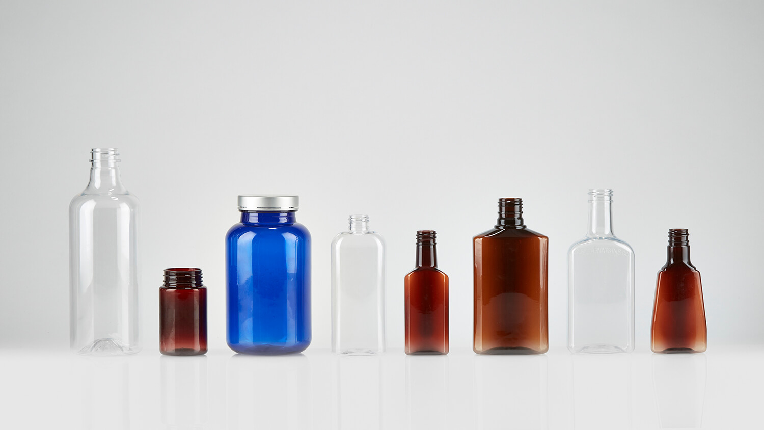 Standard PET bottles and jars with screw-on caps in a variety of colors.