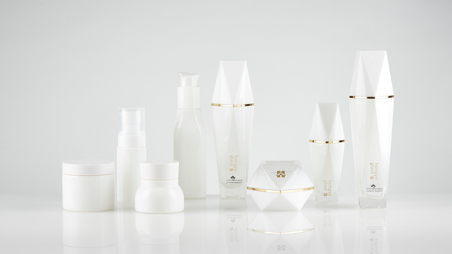 White opal cosmetic glass bottles with custom molding and branding.