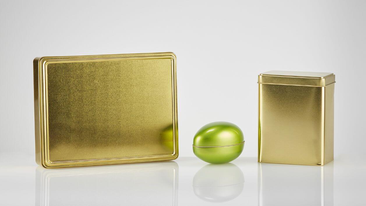 Luxury gold tin boxes and containers for upscale product packaging.