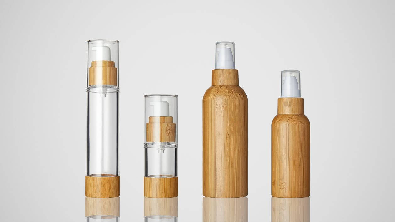 Airless plastic bottles with bamboo-style components for eco-forward aesthetics.