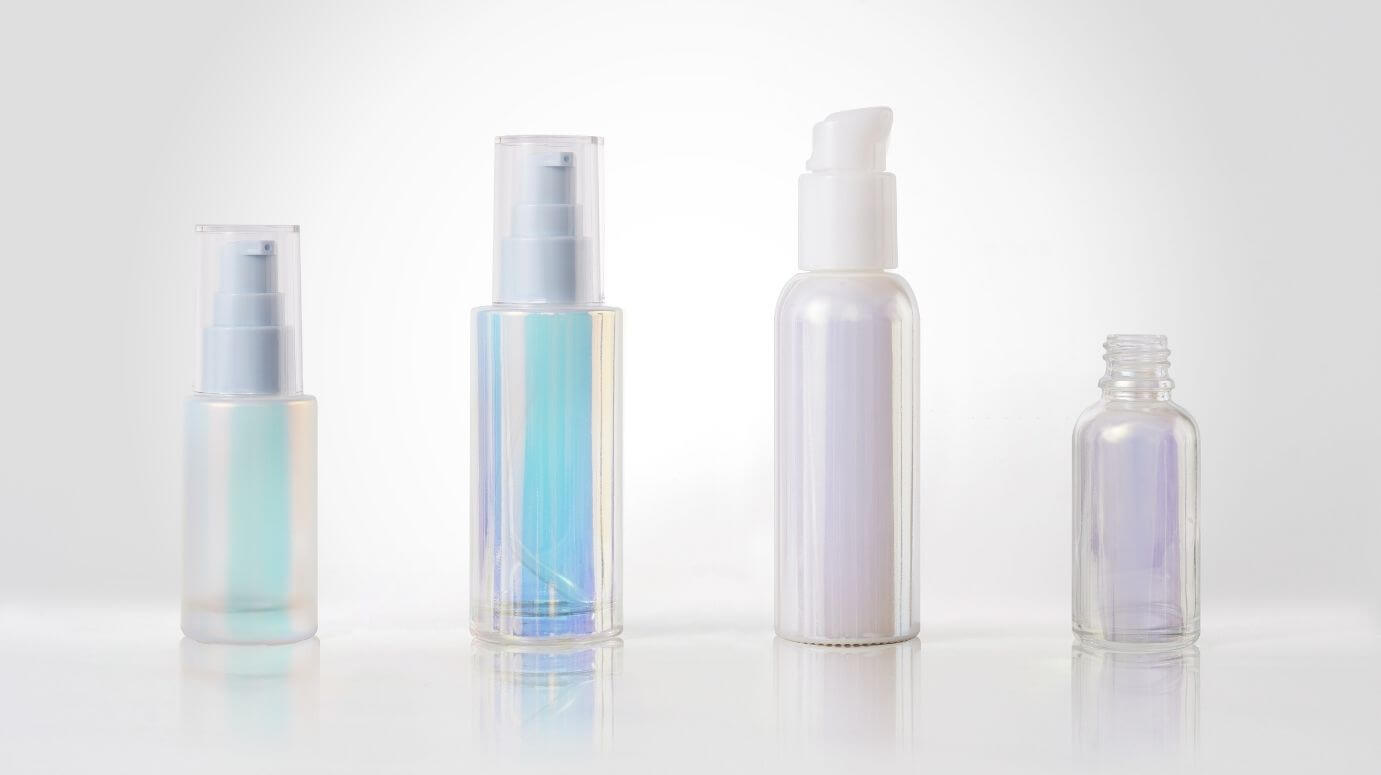 Cosmetic glass bottles with opal decorations in various colors.