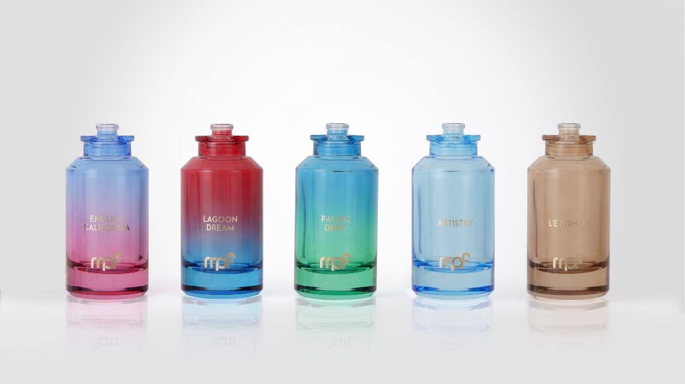 Perfume bottles decorated with gradient colors and branding.