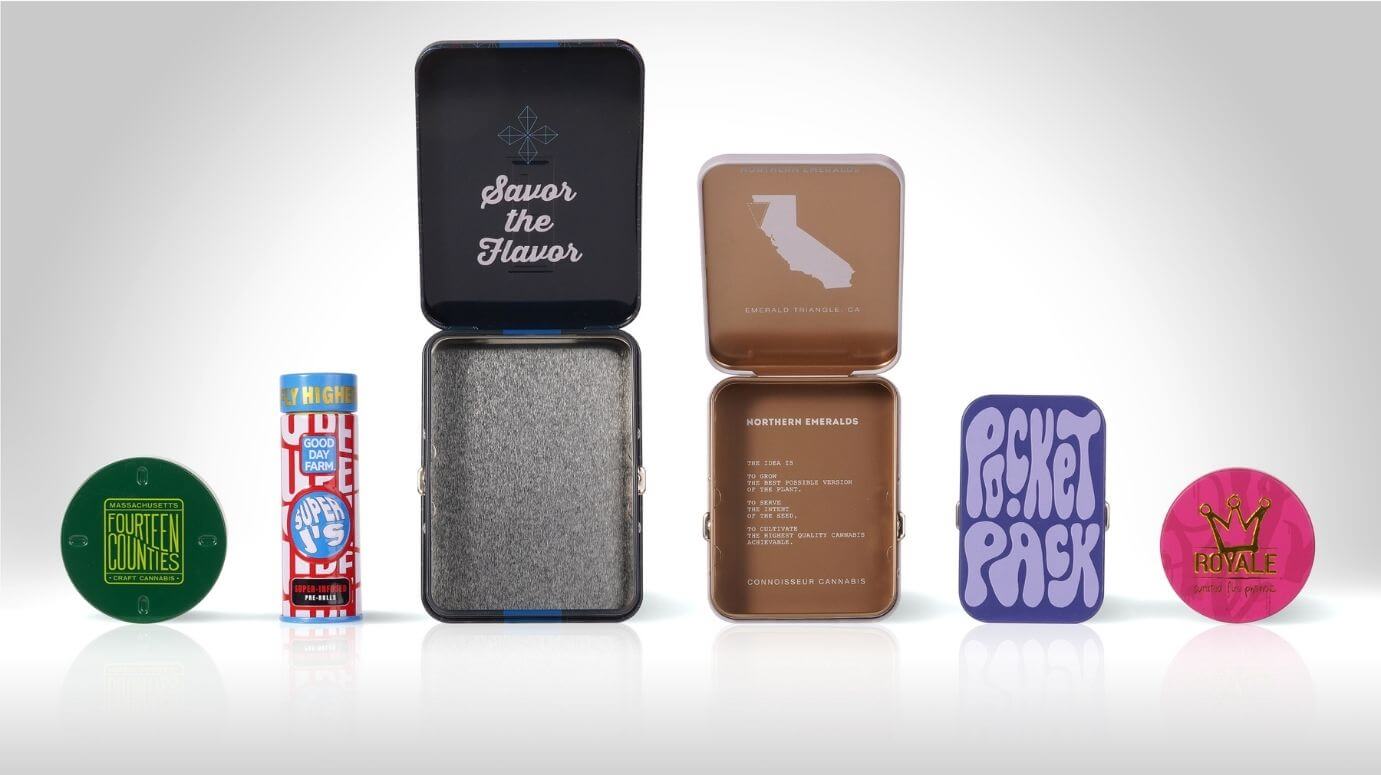 Assorted decorated tin jars in multiple sizes, shapes, and finishes.