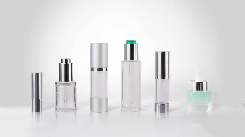 Metallized cosmetic packaging bottles with reflective finishes.