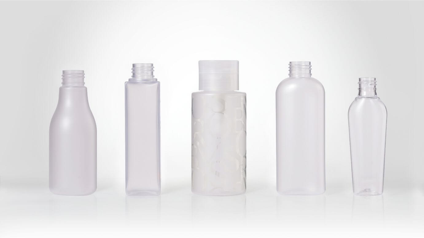 Matte-finish plastic bottles in assorted shapes for personal care and cosmetics.