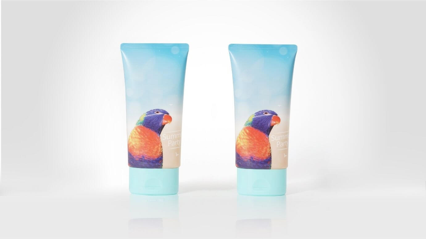 Printed plastic tubes decorated with flexography, featuring a detailed bird design and logo.