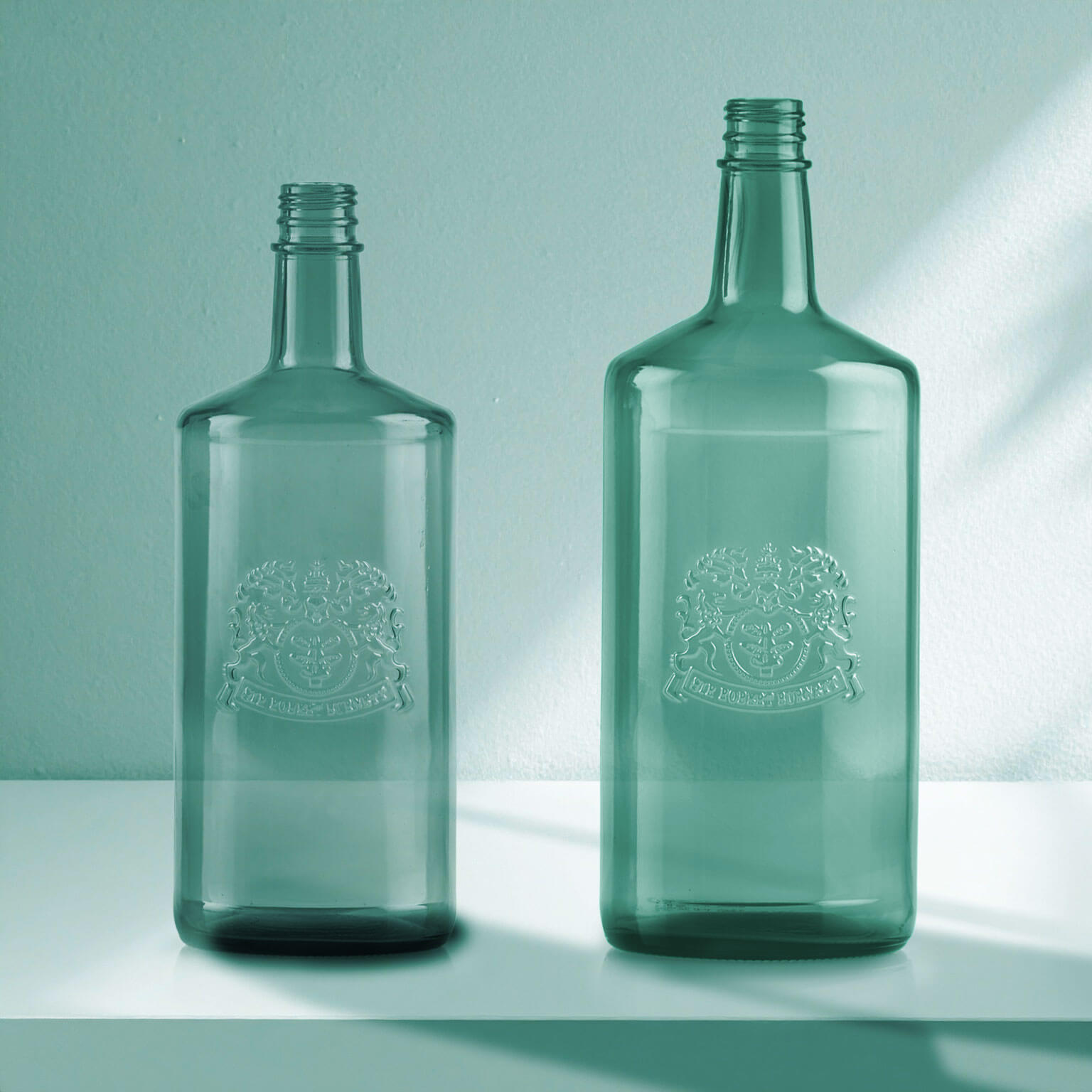 Embossed and Debossed glass bottles on display.