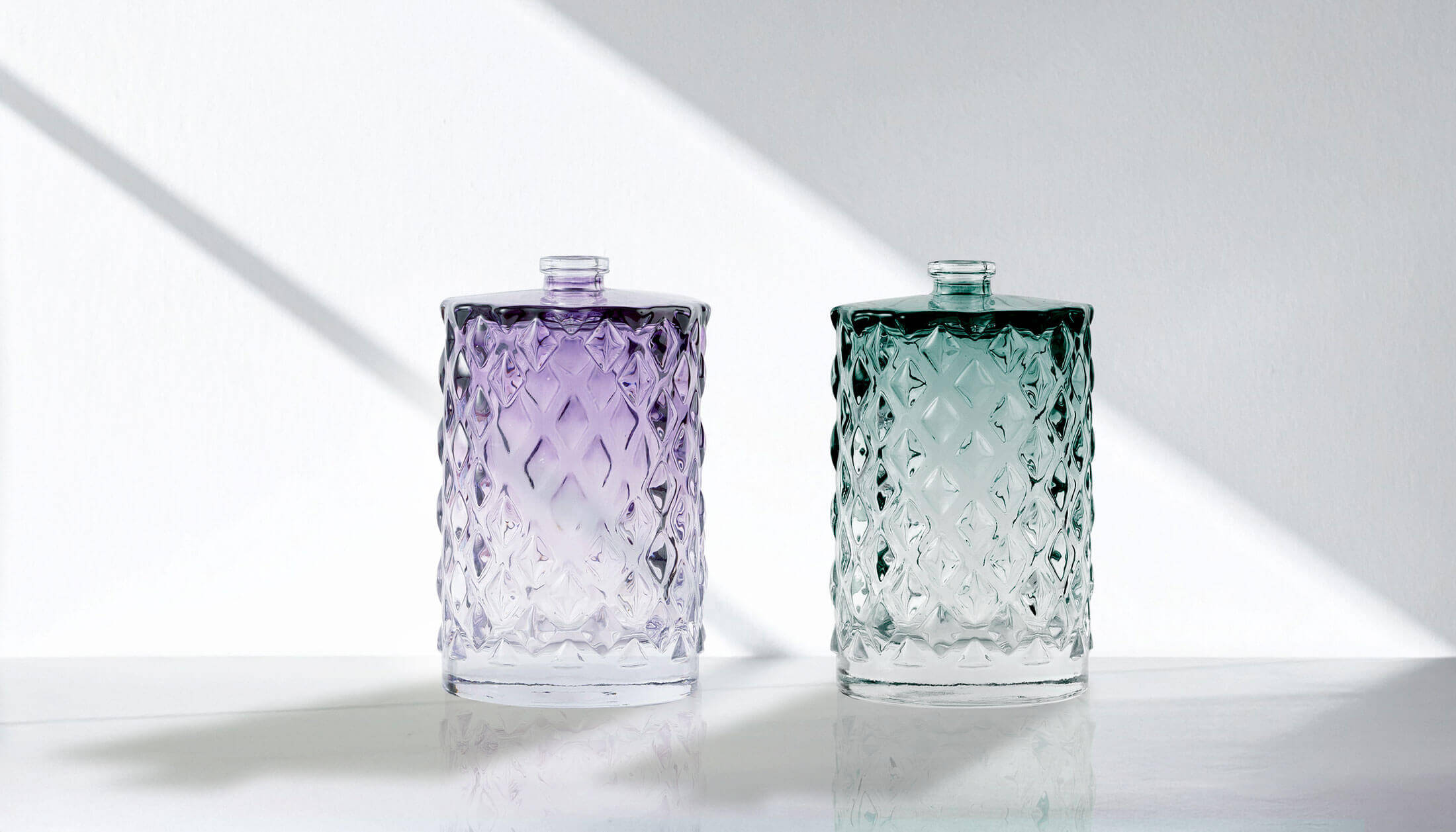 Glass bottles with color spray decorations by Evergreen.