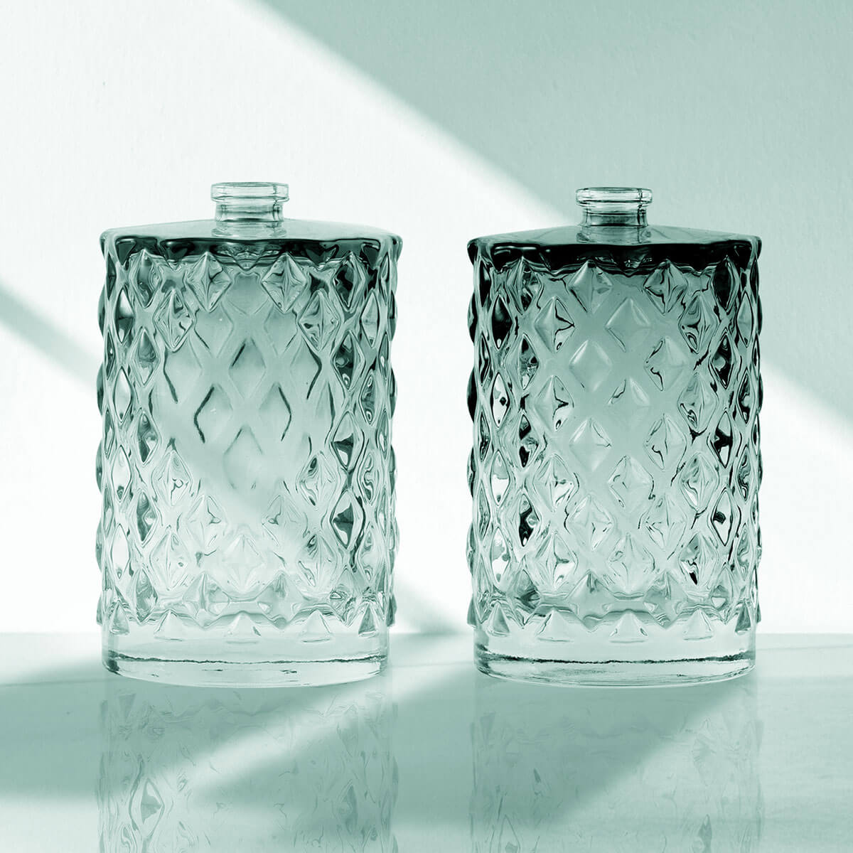 Bottles decorated with color spray next to each other, with fine glass molding.