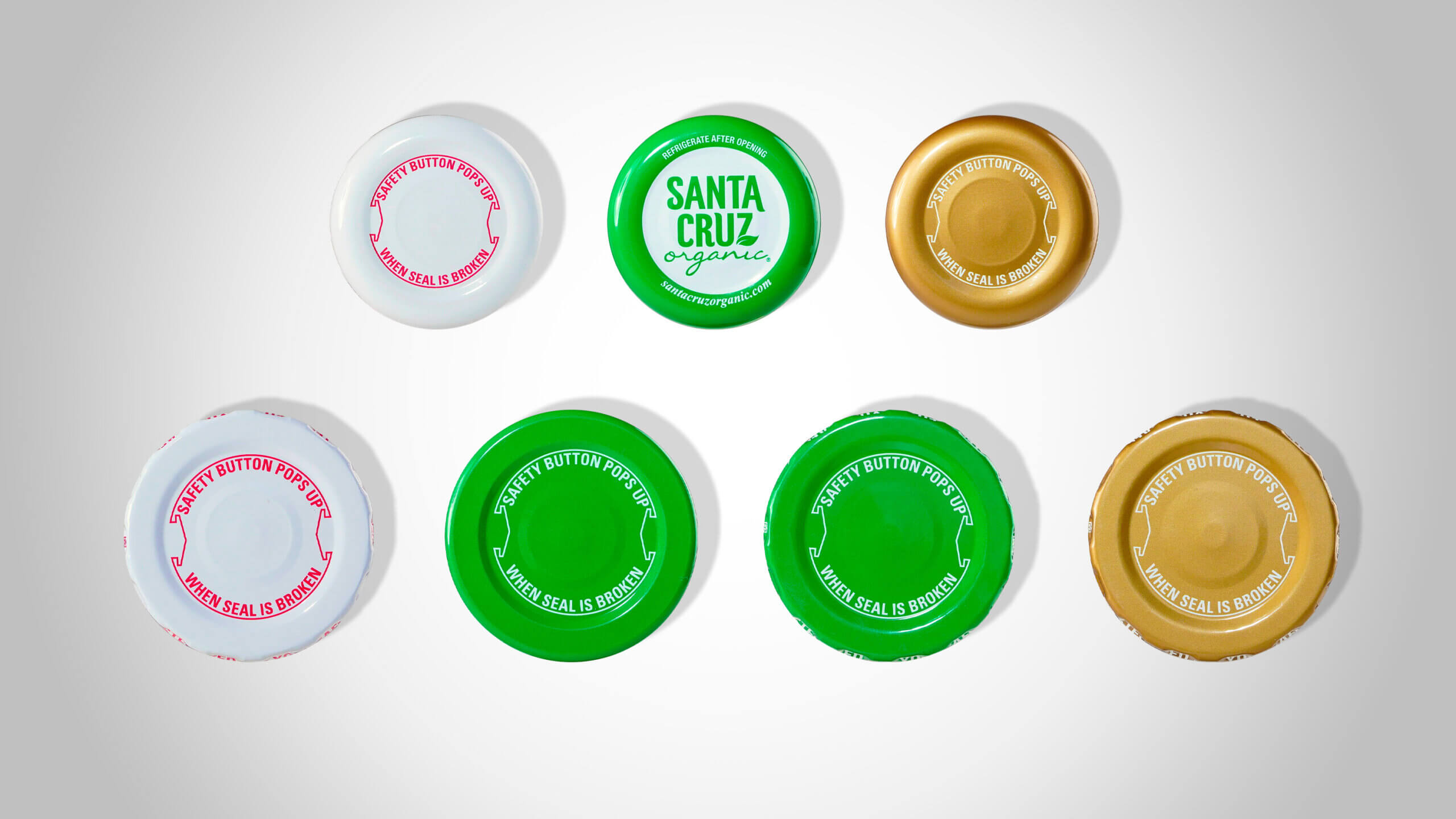 Tinplate lug caps by Evergreen, with branding and decorations.