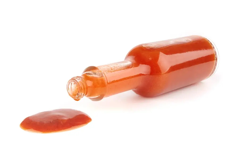 Woozy bottle shape examples, with a filled hot sauce bottle.
