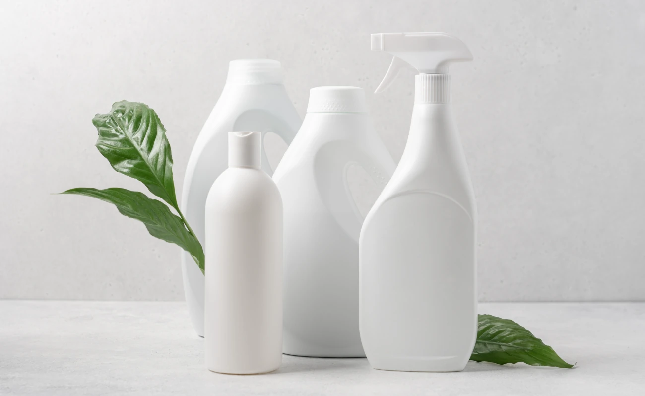 Sustainable packaging bottles with leaves behind them.