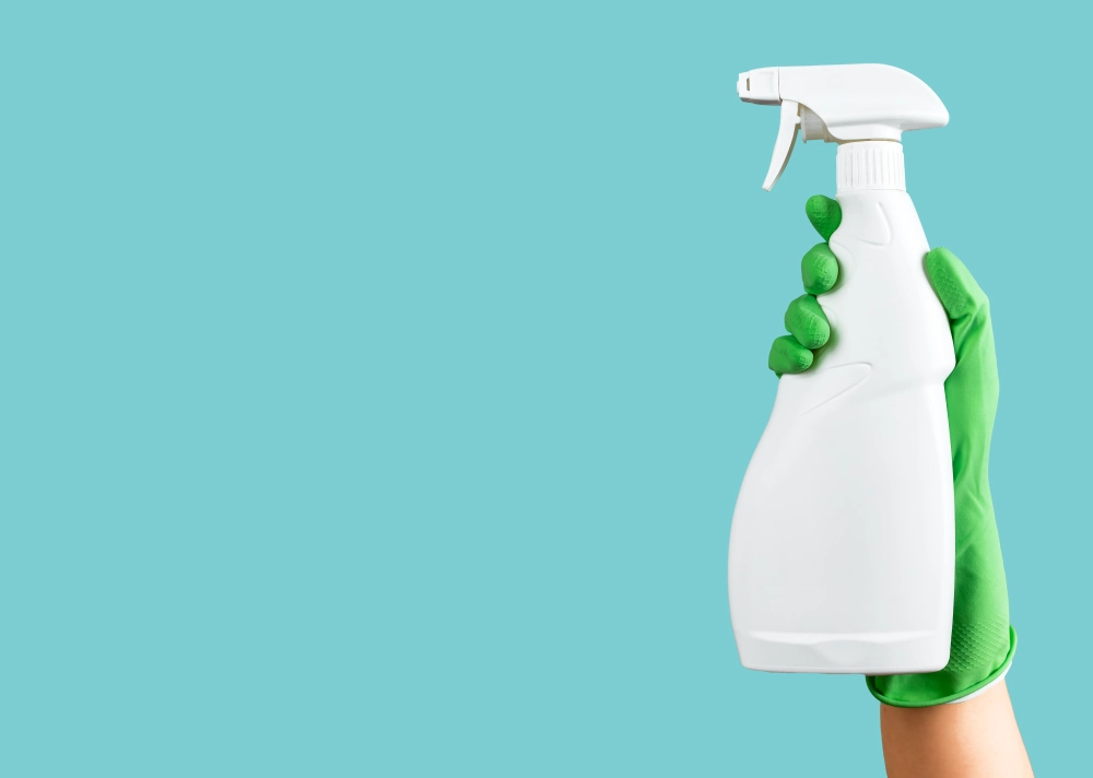 Trigger sprayer being held with cleaning gloves.