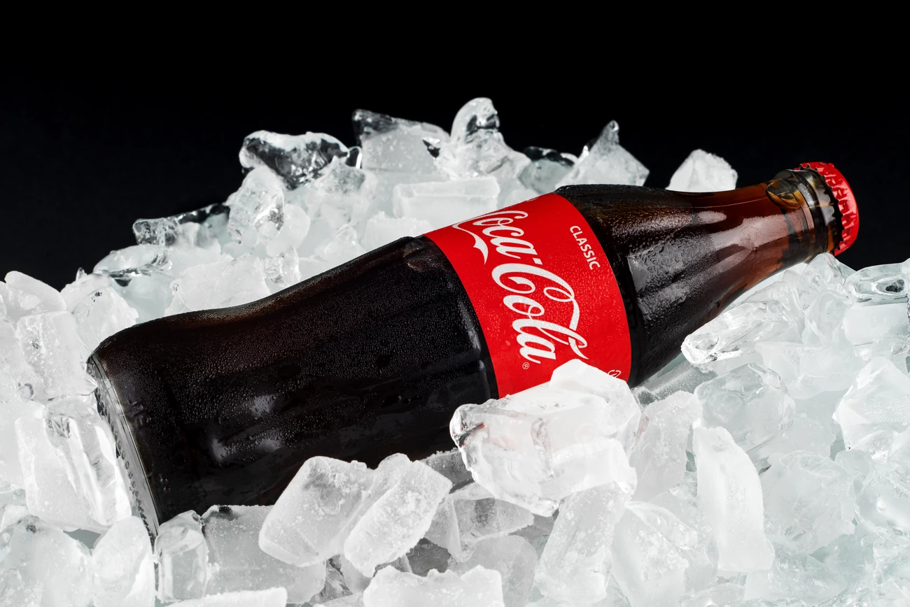 Glass coke bottle on Ice, with labeling.