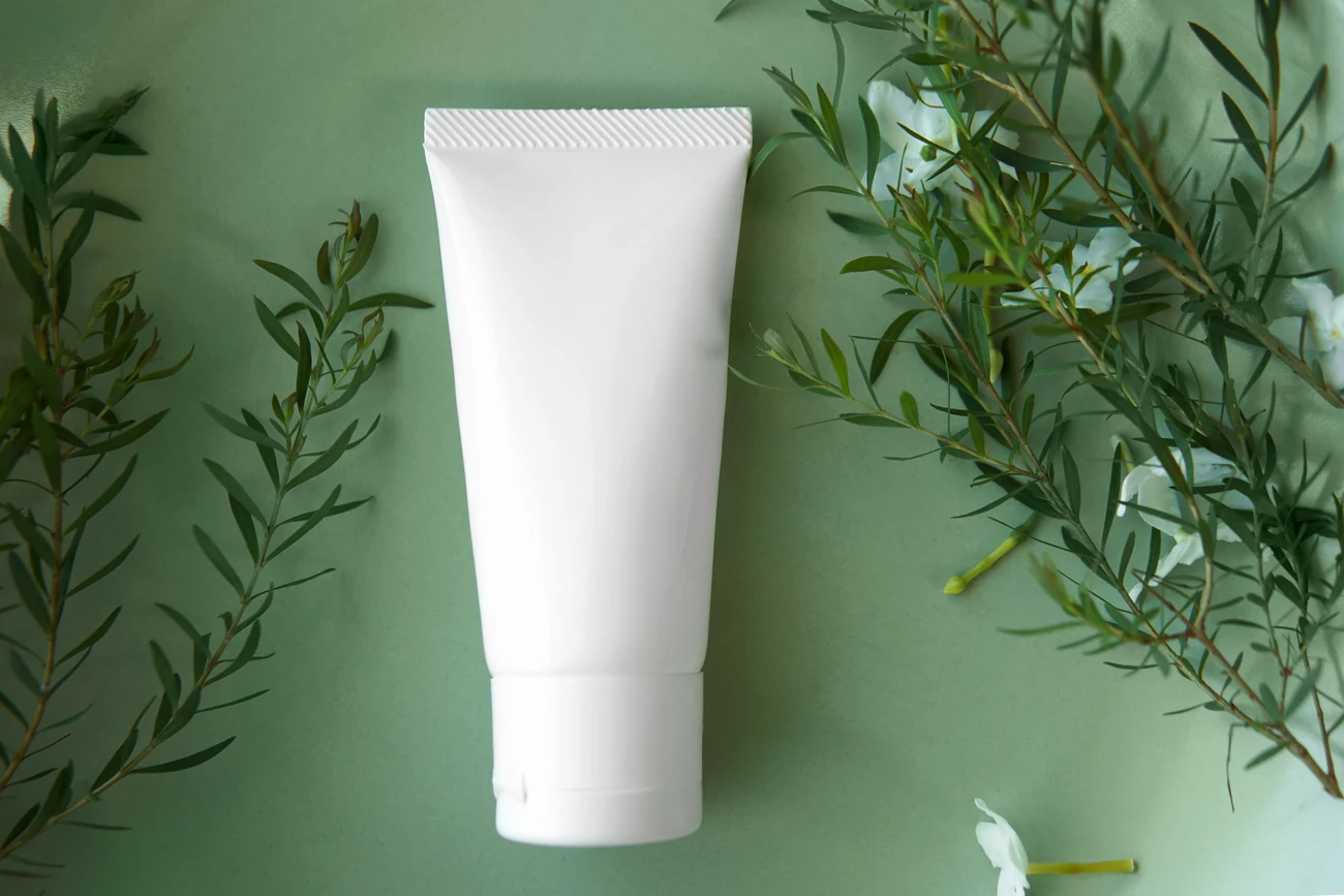 Sustainable white tube on green background.