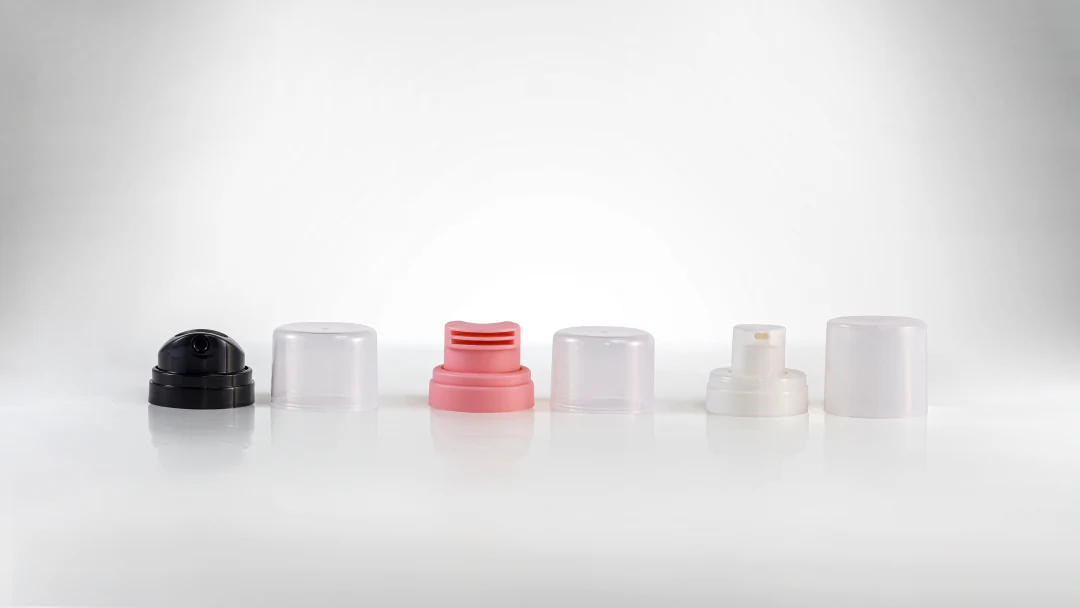Variety of aerosol actuators on display in different colors and sizes.