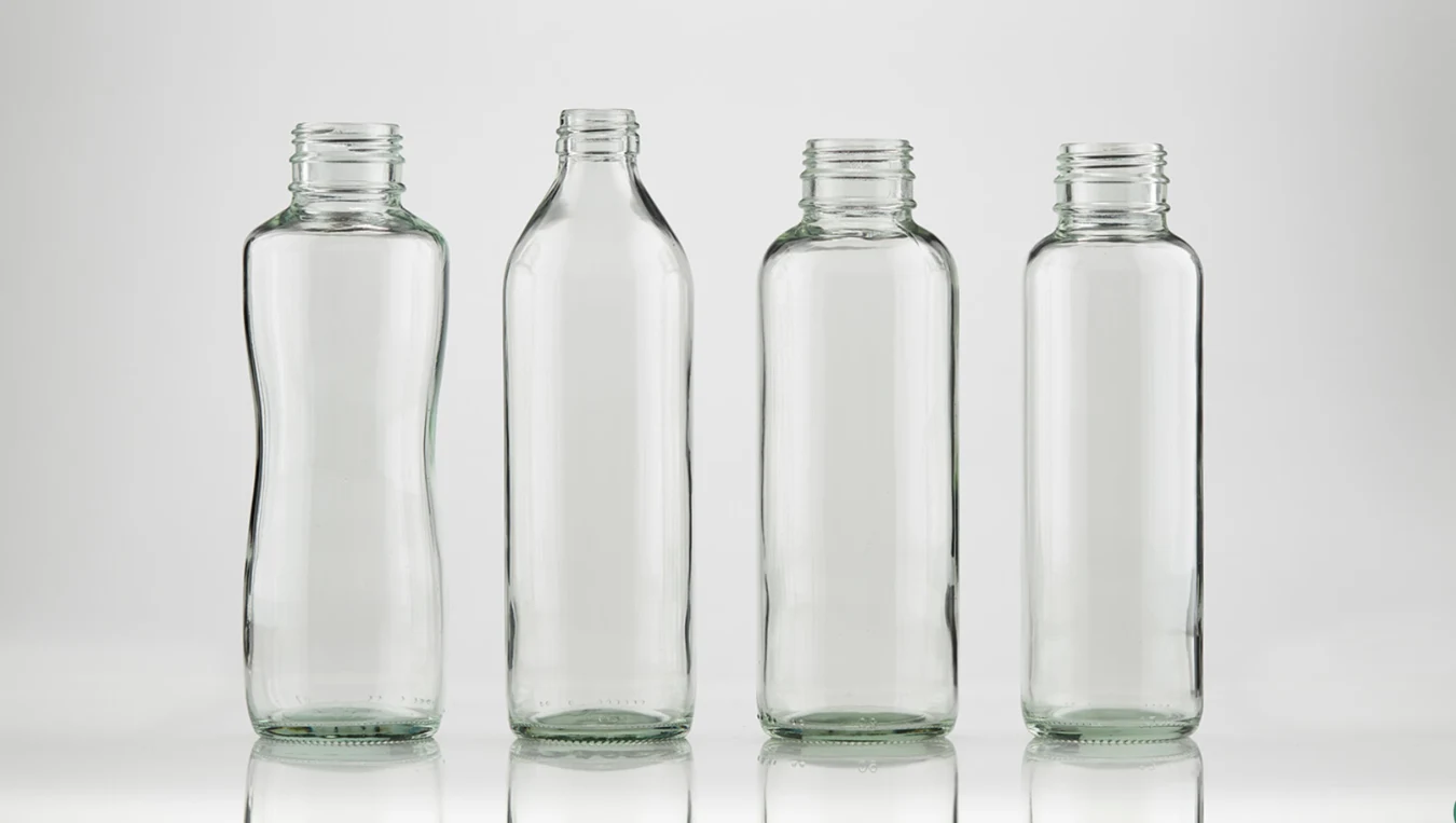 Four flint glass Bottles by Evergreen, with different shapes.