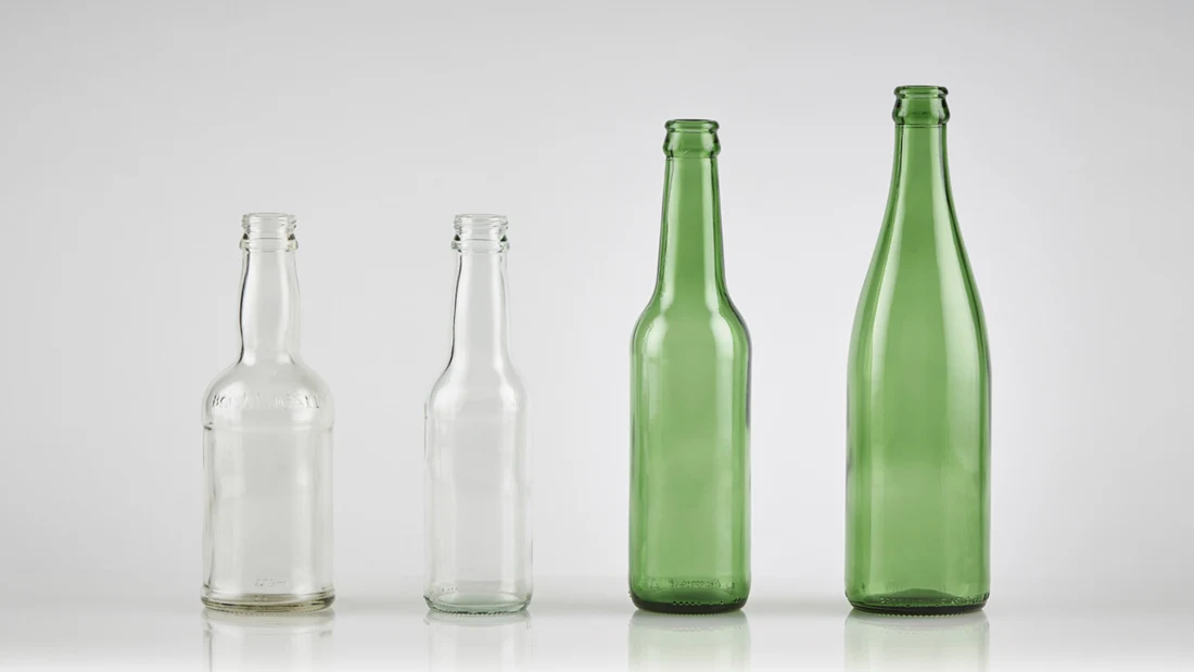 Green glass next to flint glass bottles.