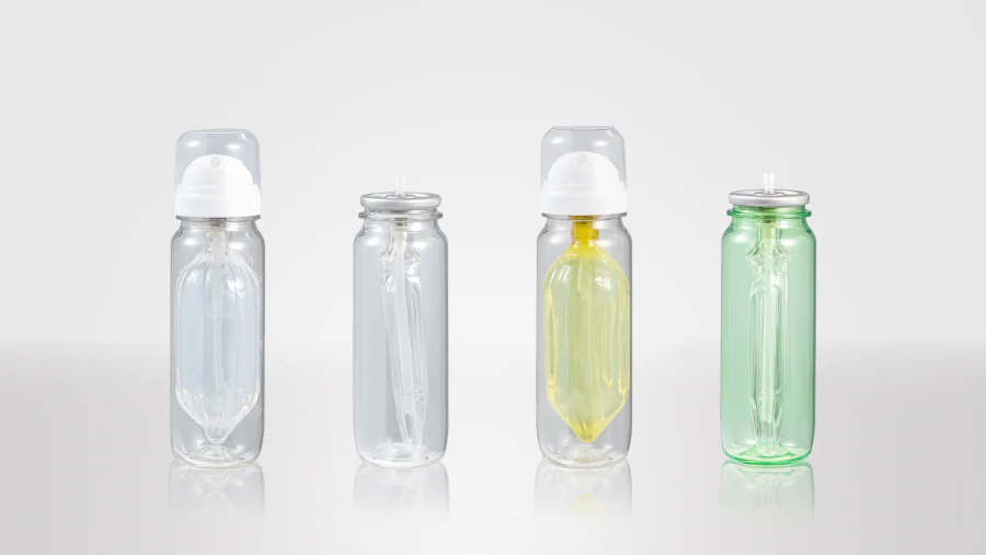 Clear and green-tinted PET aerosol bottles with visible internal collapsible pouches and metal valve cups, including bottles fitted with white spray actuators and clear protective caps.