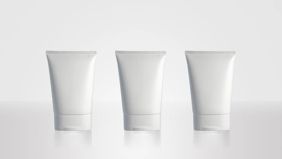 Large-diameter D75 white plastic squeeze tubes with broad tapered bodies, heat-sealed top seams, and wide matching white dispensing caps.