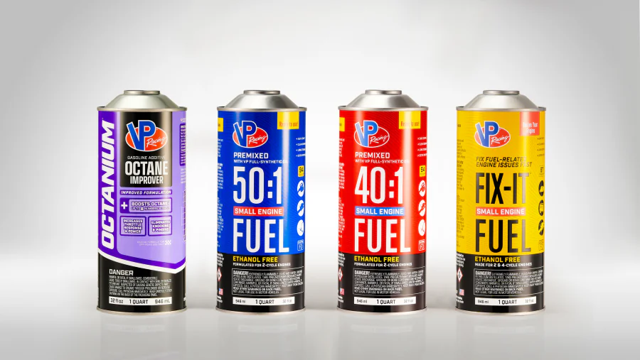 Tall cylindrical metal quart cans with domed shoulders and top closures, shown with purple, blue, red, and yellow printed automotive fuel product labels.