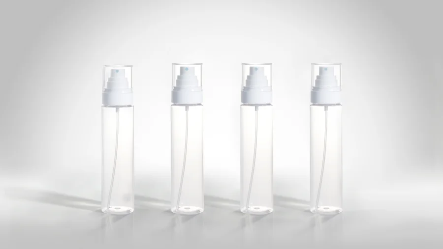 Clear cylindrical spray bottles fitted with white wide-spray fine mist pumps, long internal dip tubes, blue-marked spray nozzles, and transparent protective overcaps.